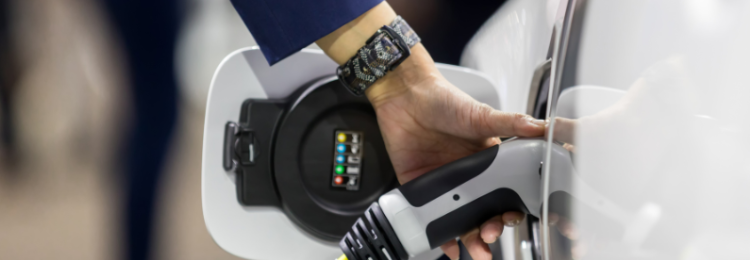Hand holding Electric car charger. Electric Vehicle EV Charging station and Charger