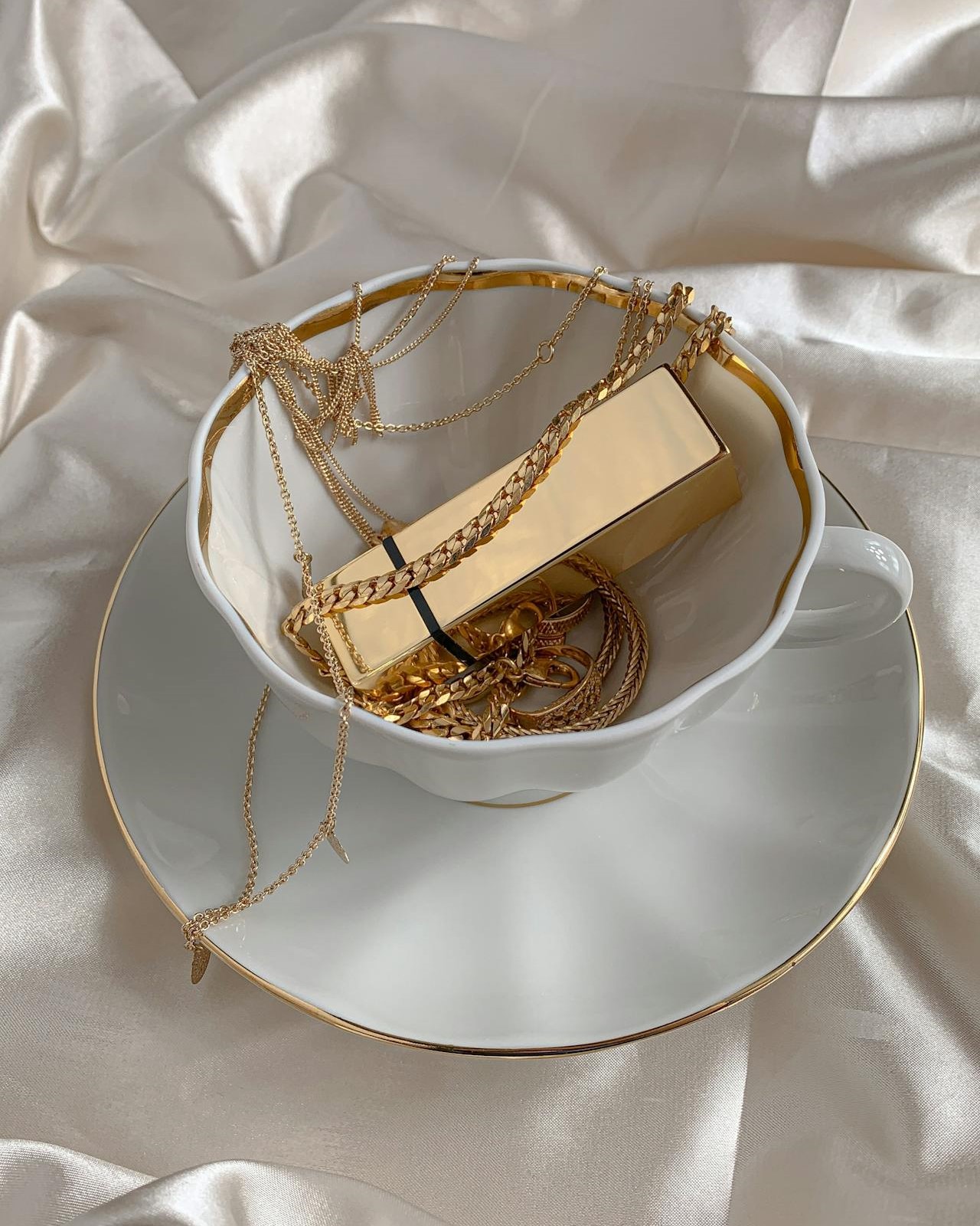 Gold Jewelries on a Cup