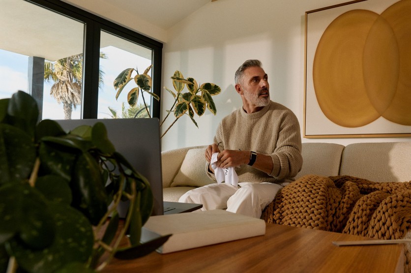 man wearing a woop band on his couch