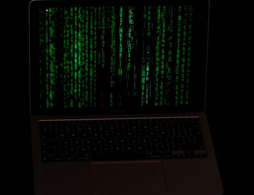 Photo of a computer screen with matrix-like green descending code