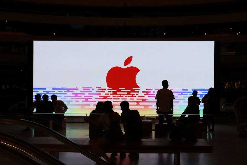 apple logo on a darkened theater screen