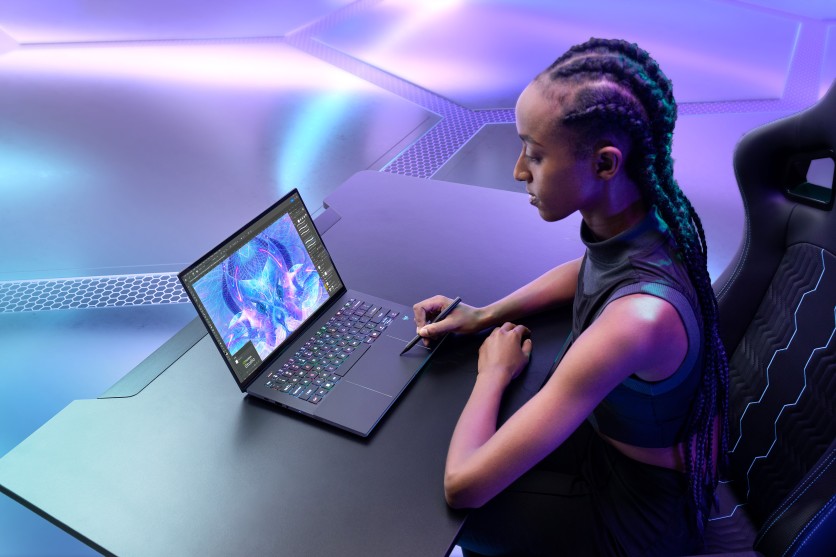Person using a Predator Triton 14 AI laptop with stylus