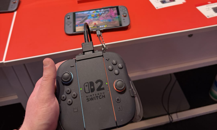 Person holding a Nintendo Switch 2 controller with console in