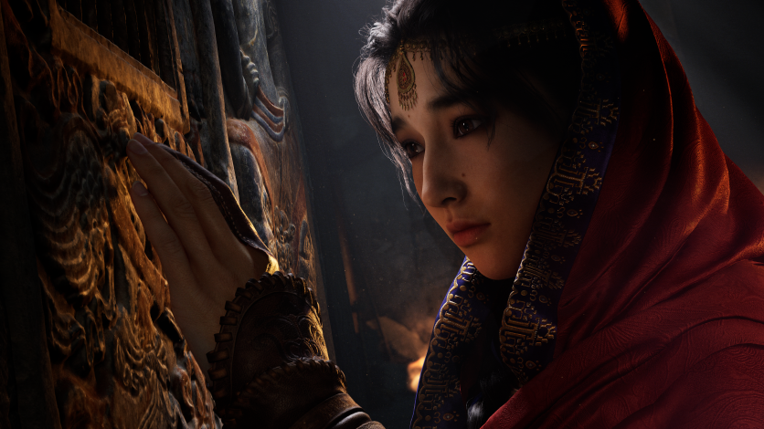 Woman in red robe touching carved stone wall