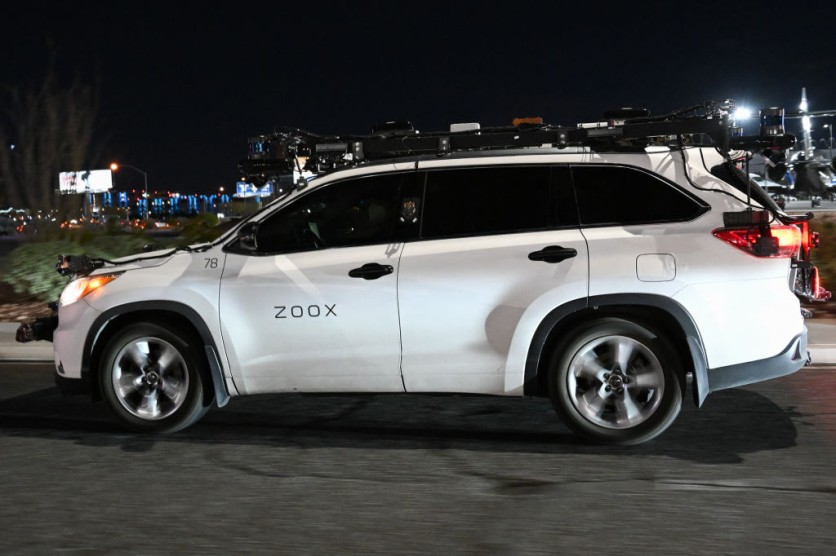 Zoox test vehicle outfitted with sensors driving at nightA Zoox