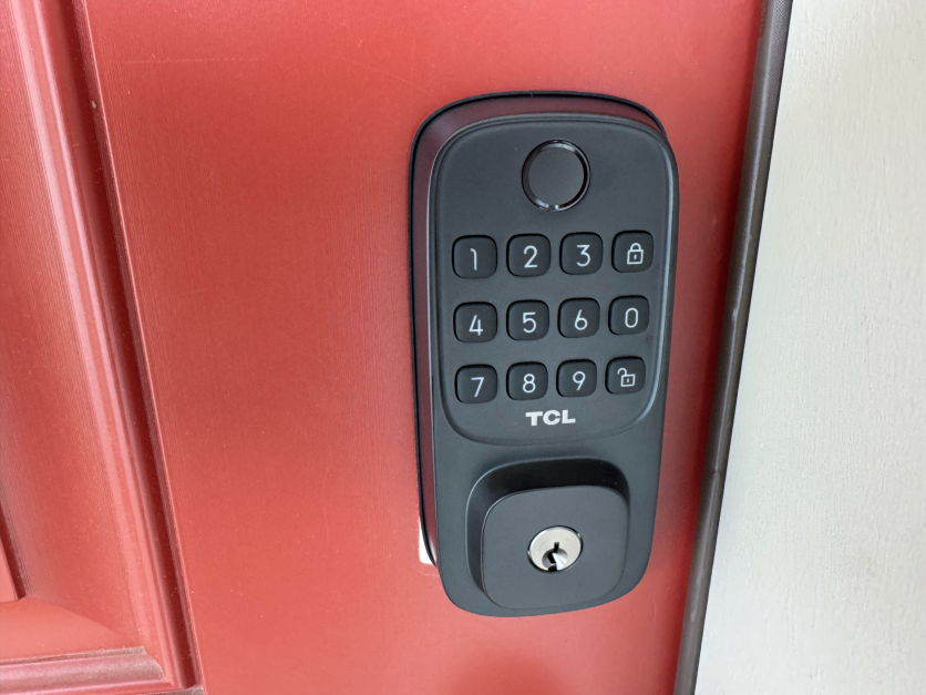 TCL D1 smart lock installed on red door