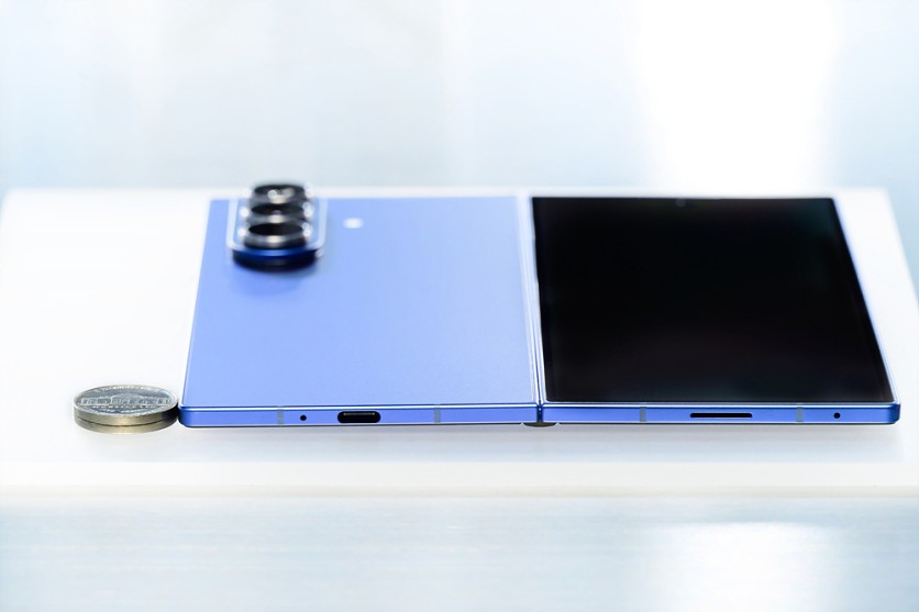 Galaxy Z Fold7 shown unfolded next to a nickel