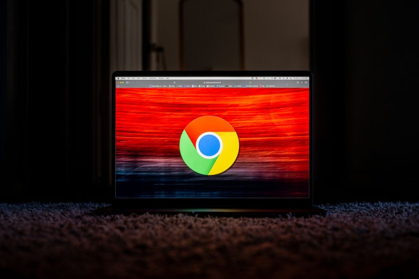 Laptop screen showing Chrome logo on red background