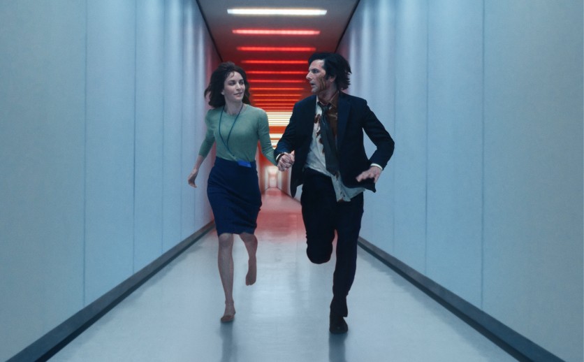 Characters from Severance running down a hallway