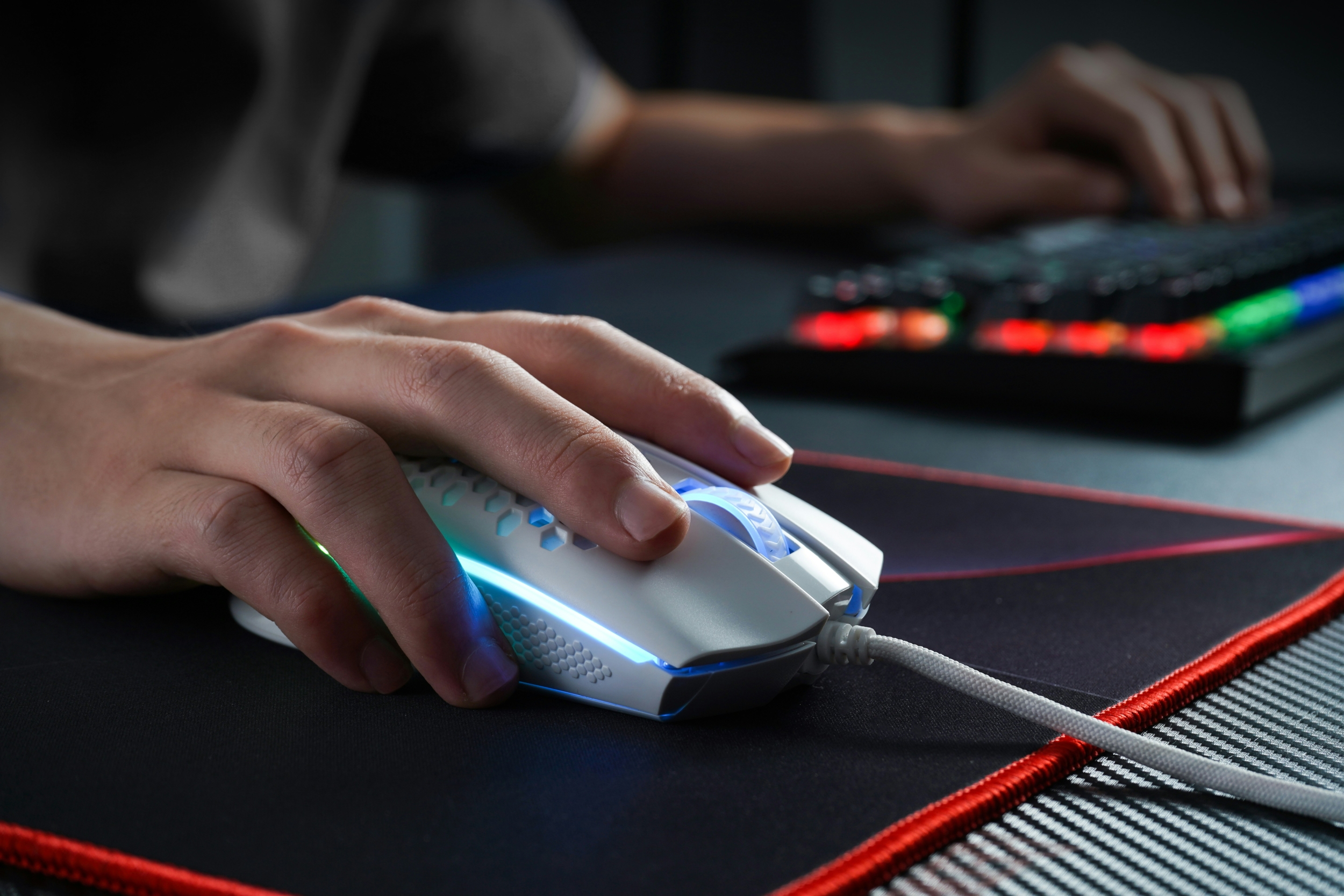 Wireless Vs Wired Mouse For Competitive Gaming Which Is Better In 2026 Person Holding Mouse Keyboarding 