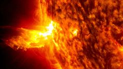 Coronal Mass Ejection material rises from the edge of the