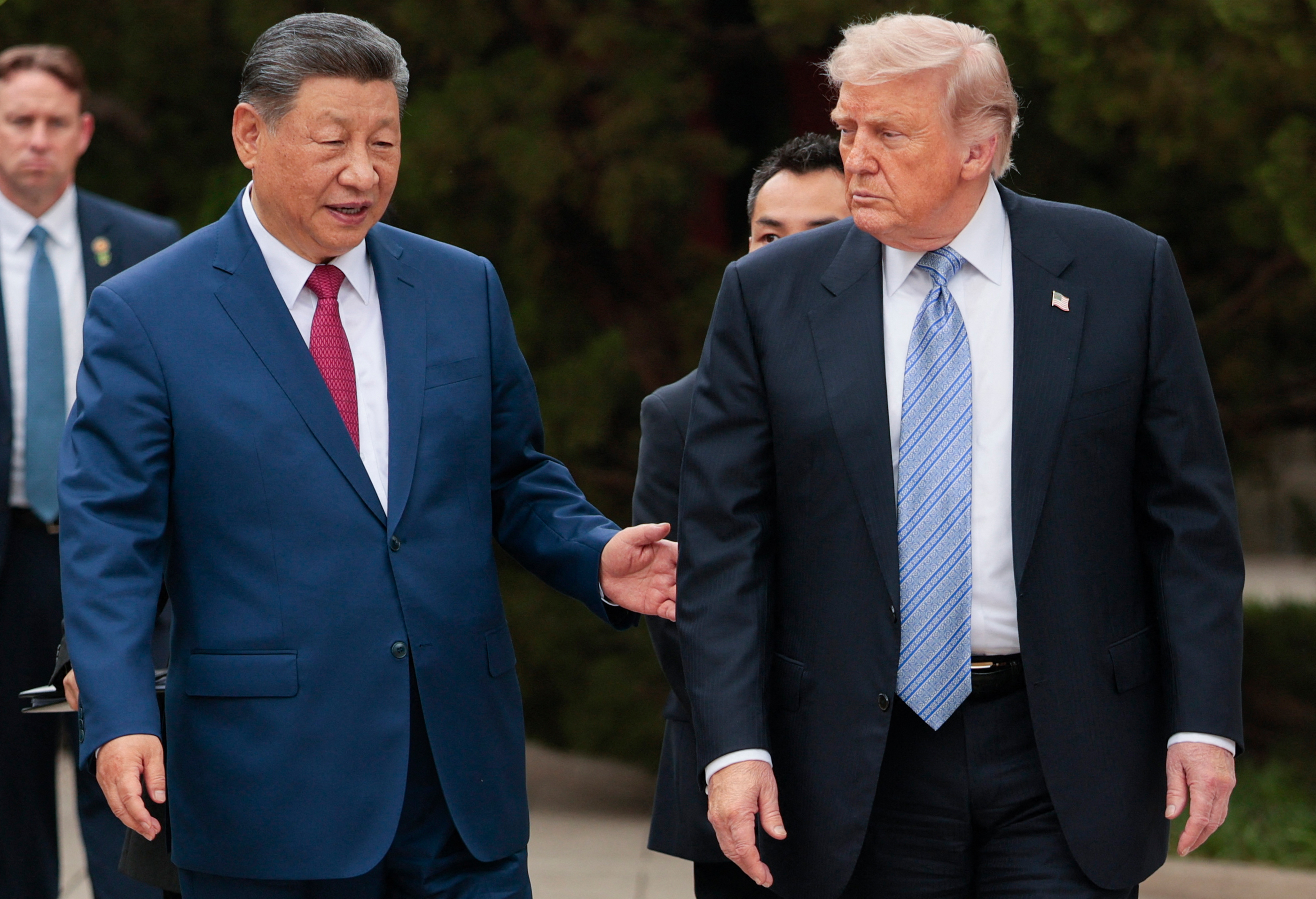 US President Donald Trump (R) walks with China's President Xi 