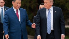 US President Donald Trump (R) walks with China's President Xi