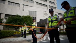 Policemen stand outside the Ansan branch of the Suwon District