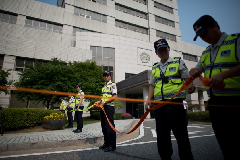 Policemen stand outside the Ansan branch of the Suwon District