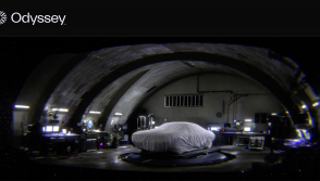 "An underground workshop with a muscle car covered in a
