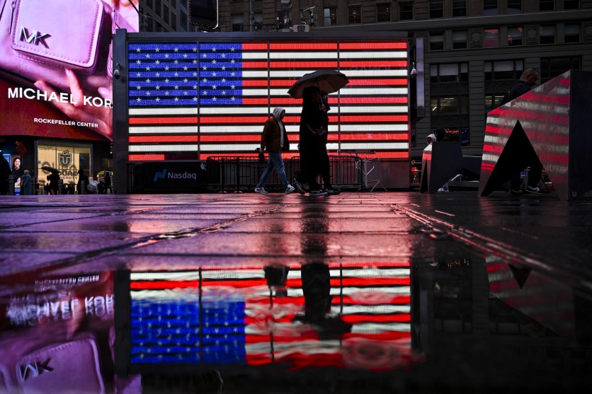 People walk past an American Flag display at Time Square