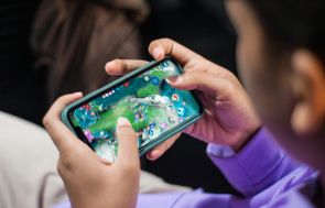 Person Playing Games on Smartphone