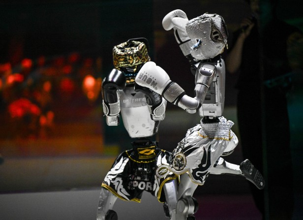 Humanoid robots perform in a kick-boxing fight during the Galaxy
