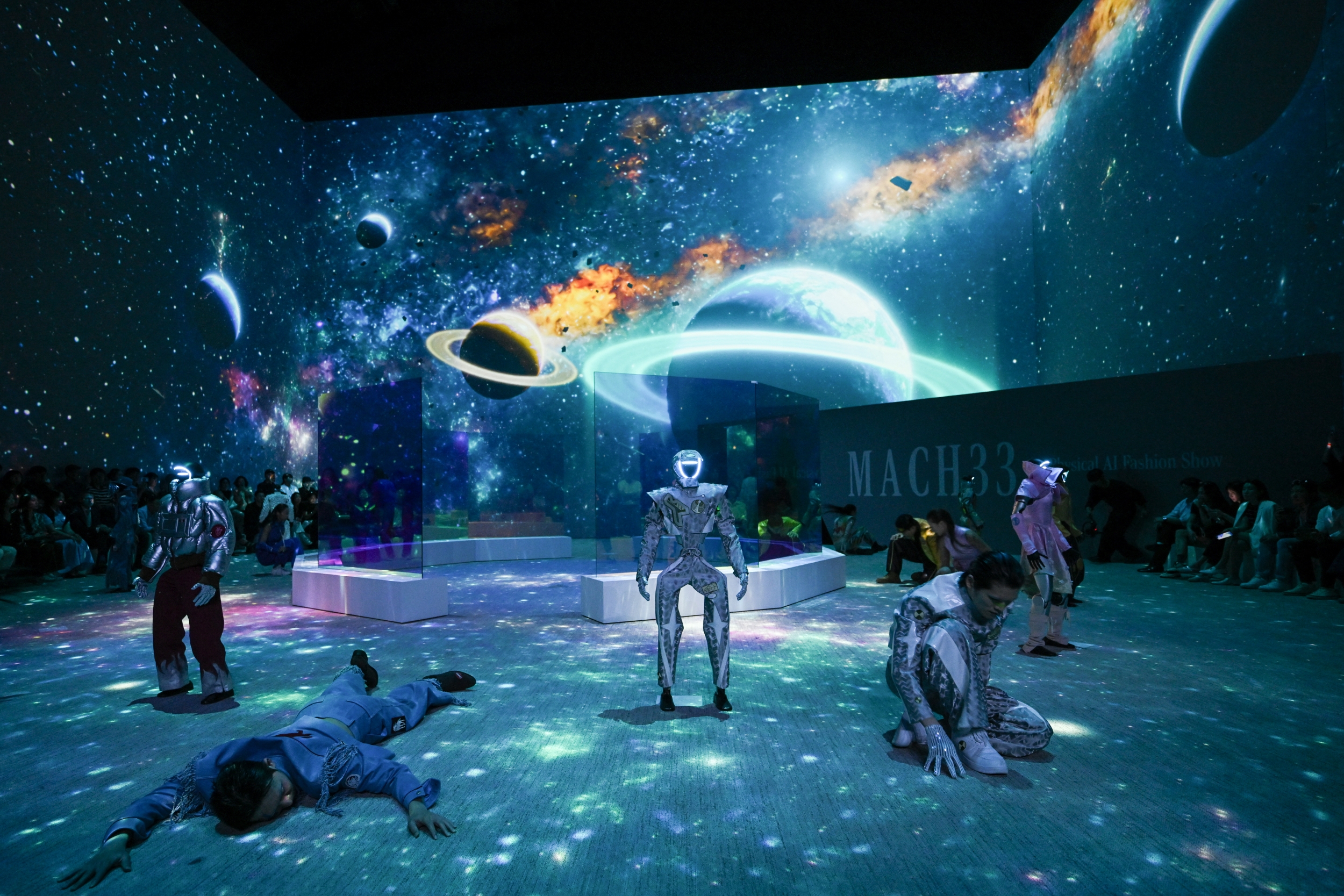 Humanoid robots and models perform as they present creations at 