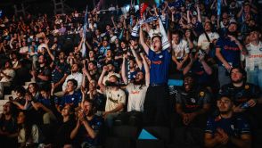 E-sport fans cheer to support their team during a League