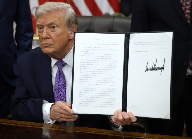 U.S. President Donald Trump displays a signed executive order in