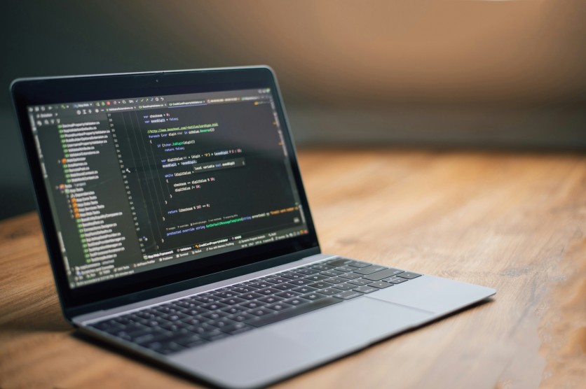 Laptop on Desk Displaying Coding Software