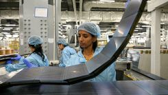 This photograph taken on November 5, 2025 shows employees inspecting