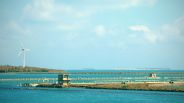 Large Body of Water and a Wind Turbine