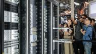 Visitors look at Wiwynn's AI data centre reference architecture display