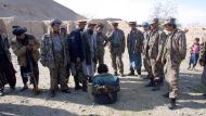 A Taliban prisoner (C) is surrounded by Afghanistan's opposition fighters
