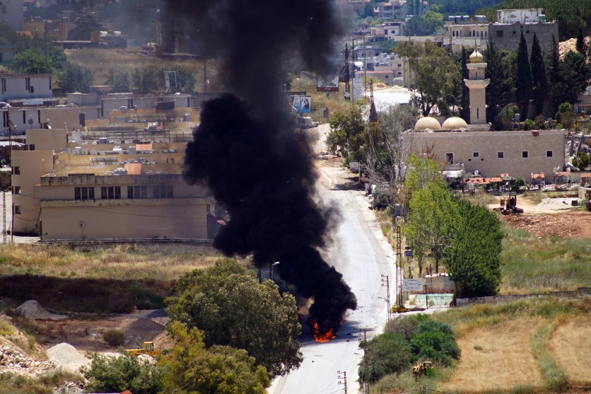 Smoke rises from a vehicle targeted by an drone attack