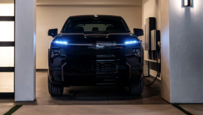 Black Chevy EV charging in garage