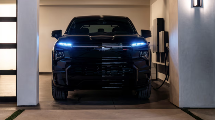 Black Chevy EV charging in garage