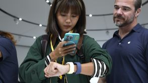 An attendee inspects a new Apple Watch during an Apple