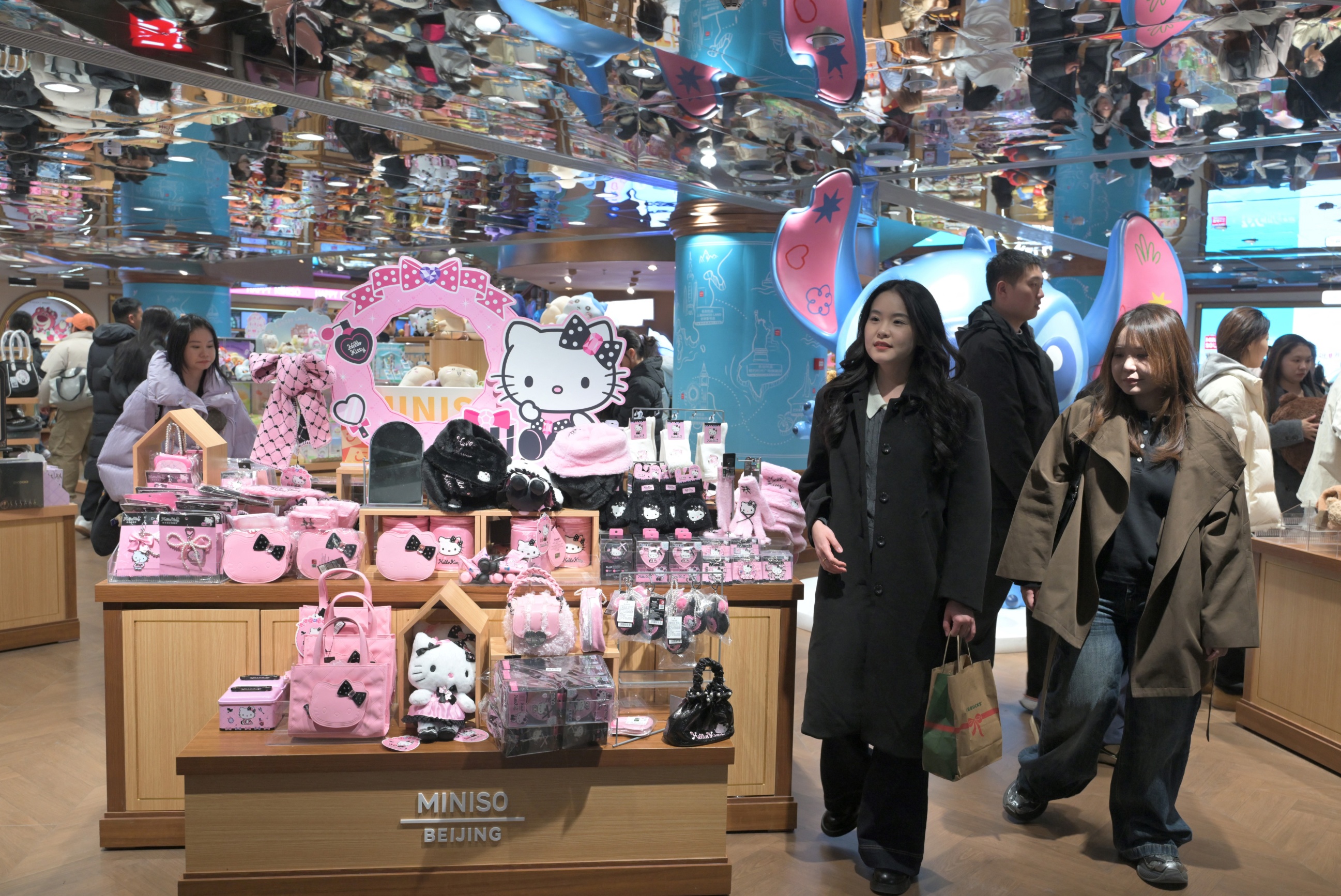 People walk past products character Hello Kitty